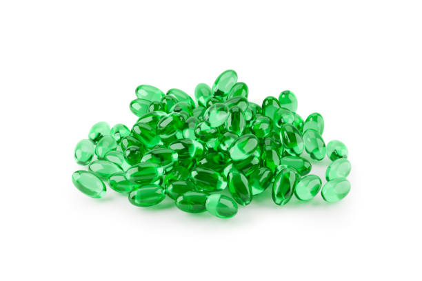istock Green Soft gelatin capsules for containing oily drugs over white background. 3D rendering. 1413080774