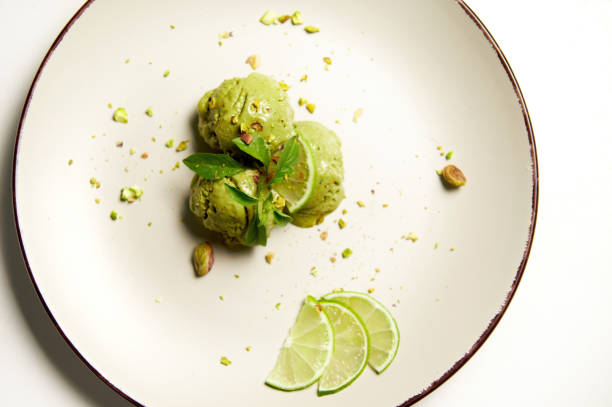Top view. Pistachio lime ice cream sorbet on plate, isolated on white background with copy ad space. Food still life