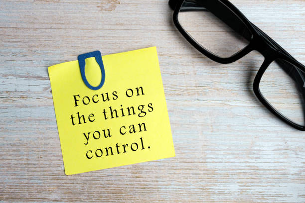 Motivational quote on sticky yellow note - Focus on the things you can control. stock photo