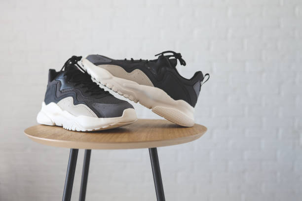 istock Stylish men's sneakers on a wooden table 1413086642