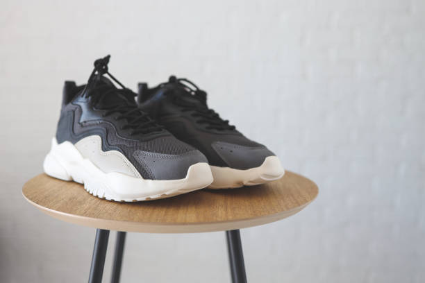 istock Stylish men's sneakers on a wooden table 1413086645