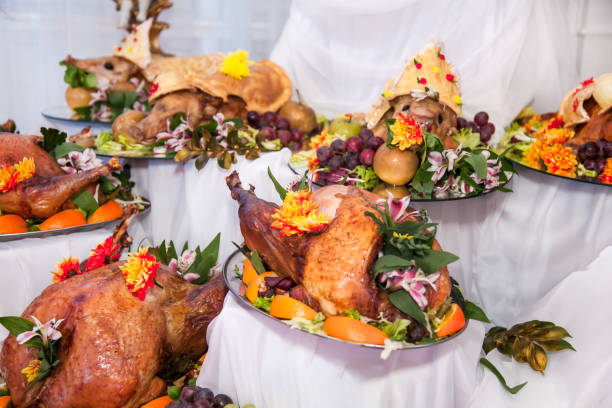 istock Buffet table with meat snacks, baked pigs in dough, cheese, turkey with fruit, decorated with candelabra and gramophone 1413087355