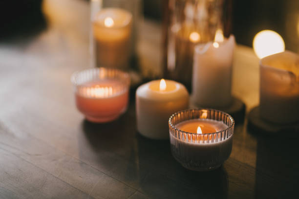 istock Candles in glasses on wooden table. 1413088187