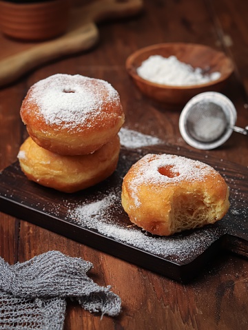 Donuts or doughtnut are made from a mixture of flour, sugar, egg yolks, yeast, and butter. shaped like a ring. sprinkled with powdered sugar to add sweetness