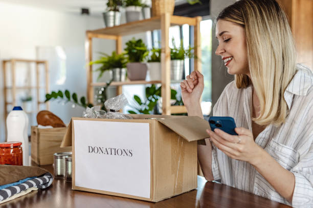 istock Young woman packing donations 1413089695