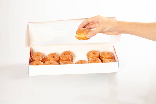 istock Box of twelve mini glazed brioche gourmet donuts 1413089797