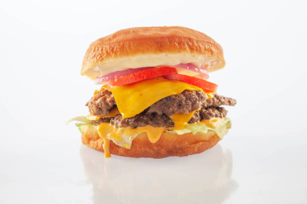 istock Double decker brioche donut cheeseburger with cheese tomatoes and onion. 1413089800
