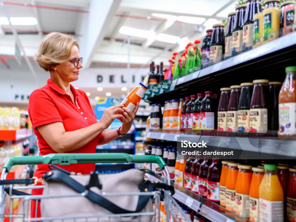Woman shopping in the supermarket Juice - Drink Stock Photo