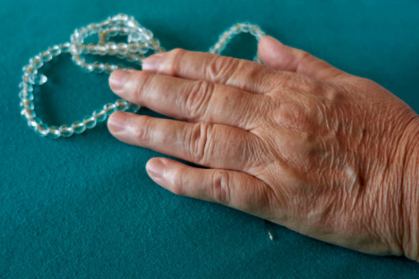 istock Senior Woman's Hand With Rosary Beads 1413091308