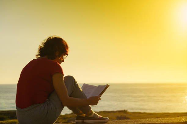 istock Woman on sea read book, relaxing 1413091653