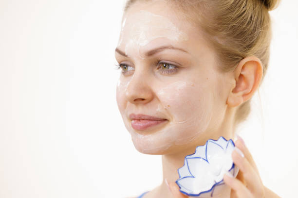 istock Girl with cream moisture cosmetic on face 1413093567
