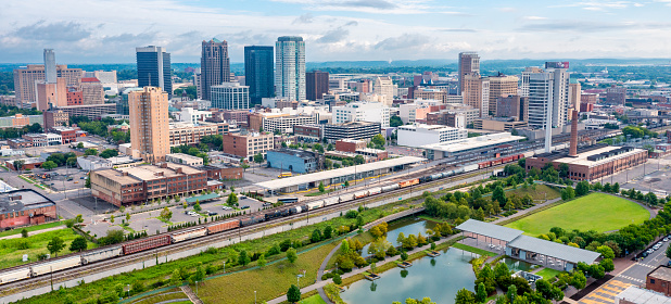 Aerial drone view of Birmingham, Alabama skyline with park and train station in the foreground.