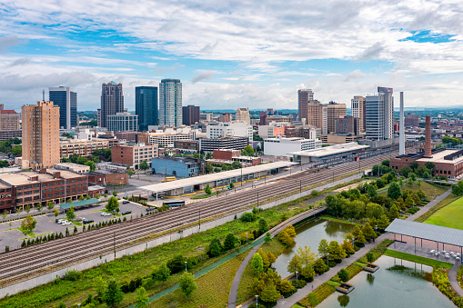 Aerial drone view of Birmingham, Alabama skyline with park and train station in the foreground.