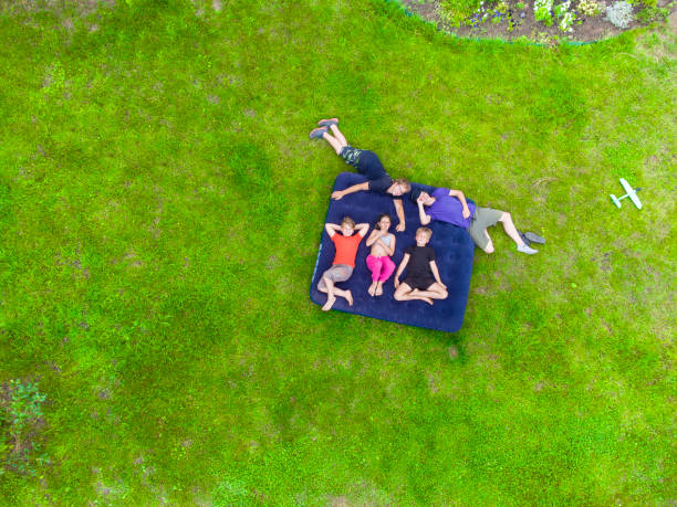 istock Happy kids lying on the grass 1413095172