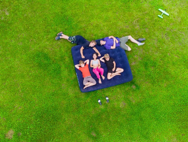 istock Happy kids lying on the grass 1413095197