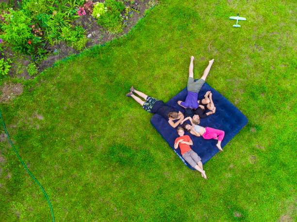 istock Happy kids lying on the grass 1413095221
