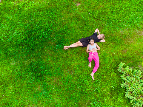 Happy kids lying on green grass