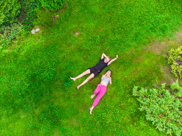 istock Happy kids lying on the grass 1413095246