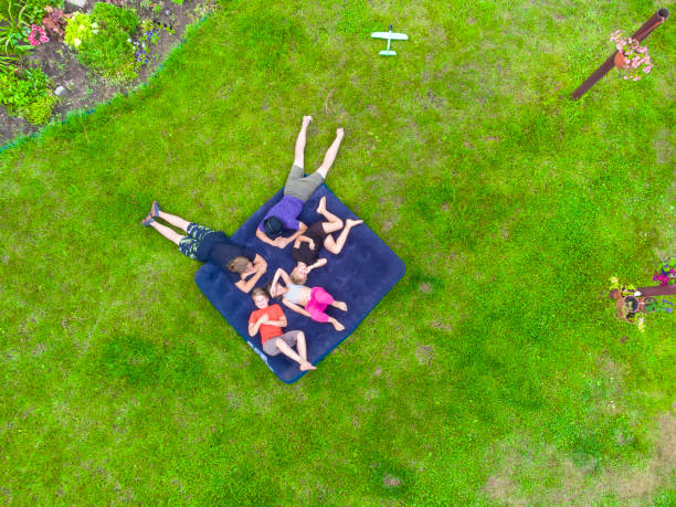 istock Happy kids lying on the grass 1413095259