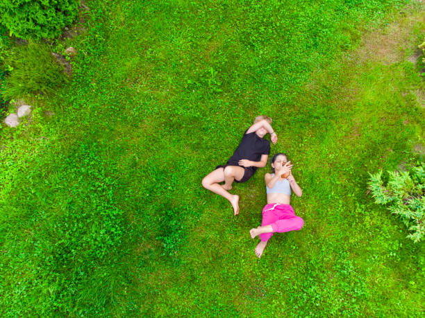 istock Happy kids lying on the grass 1413095284