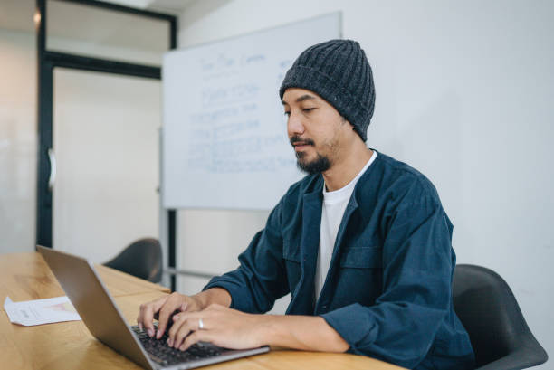 istock Hipster asian man sitting and study with laptop. 1413100133