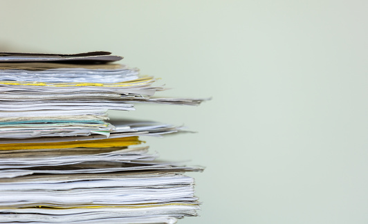 Stack of paperwork on a light grey background