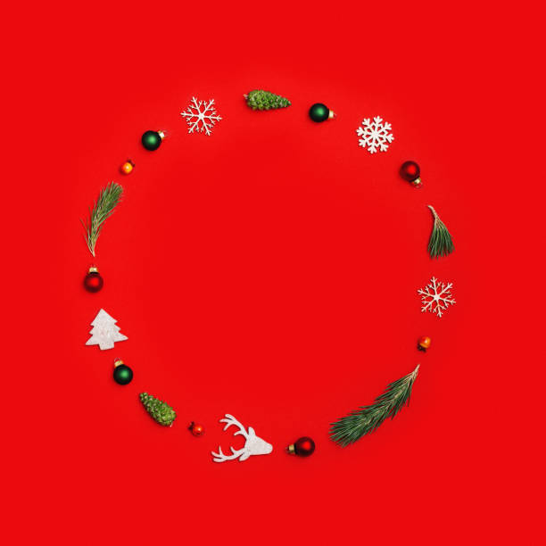 istock Christmas frame with natural decorations, wooden snowflake and christmas tree, pine cone on red 1413104299