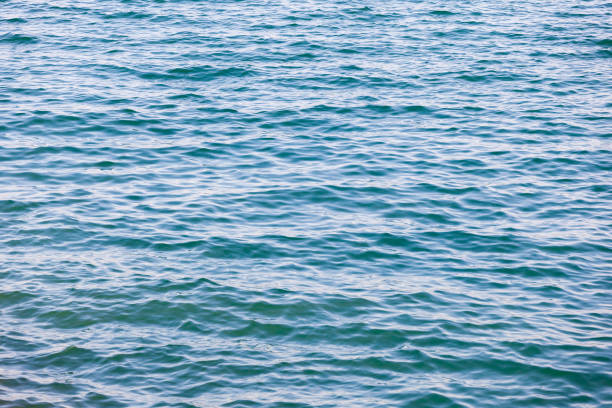 istock Blue turquoise transparent water surface of a sea  with small waves 1413107311
