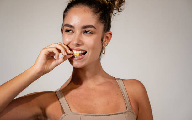 istock Happy young woman taking vitamins 1413108826
