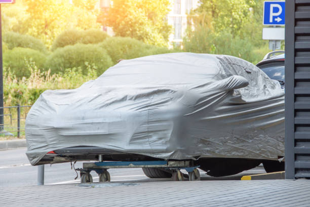 istock Car under a protective cover in the parking lot. 1413116907