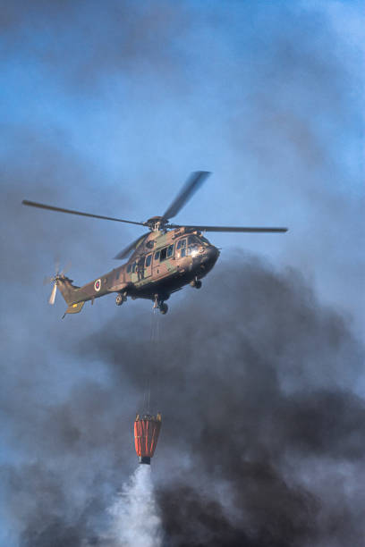 istock Military helicopter assists firefighters in extinguishing forest fire 1413117985
