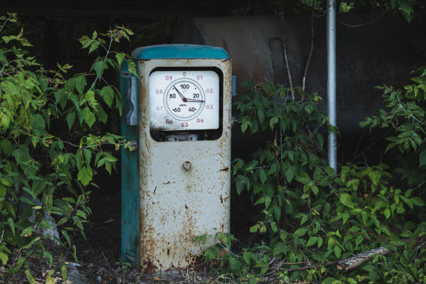 alte rostige verlassene tankstelle mit gras und bäumen bewachsen - old station natural gas russia stock-fotos und bilder