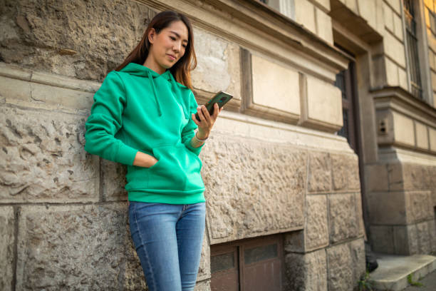 istock Woman texting message on mobile phone at city 1413120335