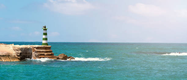 istock Lighthouse tower on sea or ocean shore 1413121637