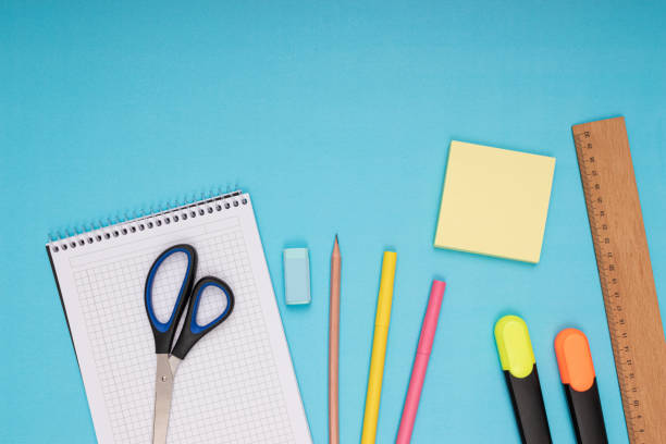 istock Notebook, scissors, colored pencils, eraser, note paper and ruler. back to school. Isolated blue background 1413123714