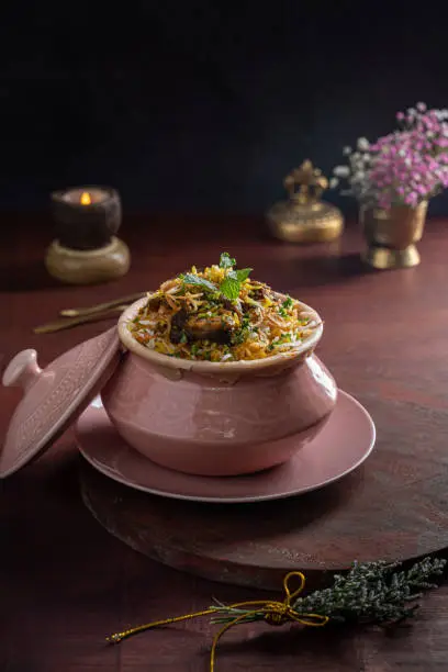 Indian and Pakistani spicy food Lucknowi Dum Pukht Biryani served in a dish isolated on dark background side view of fastfood