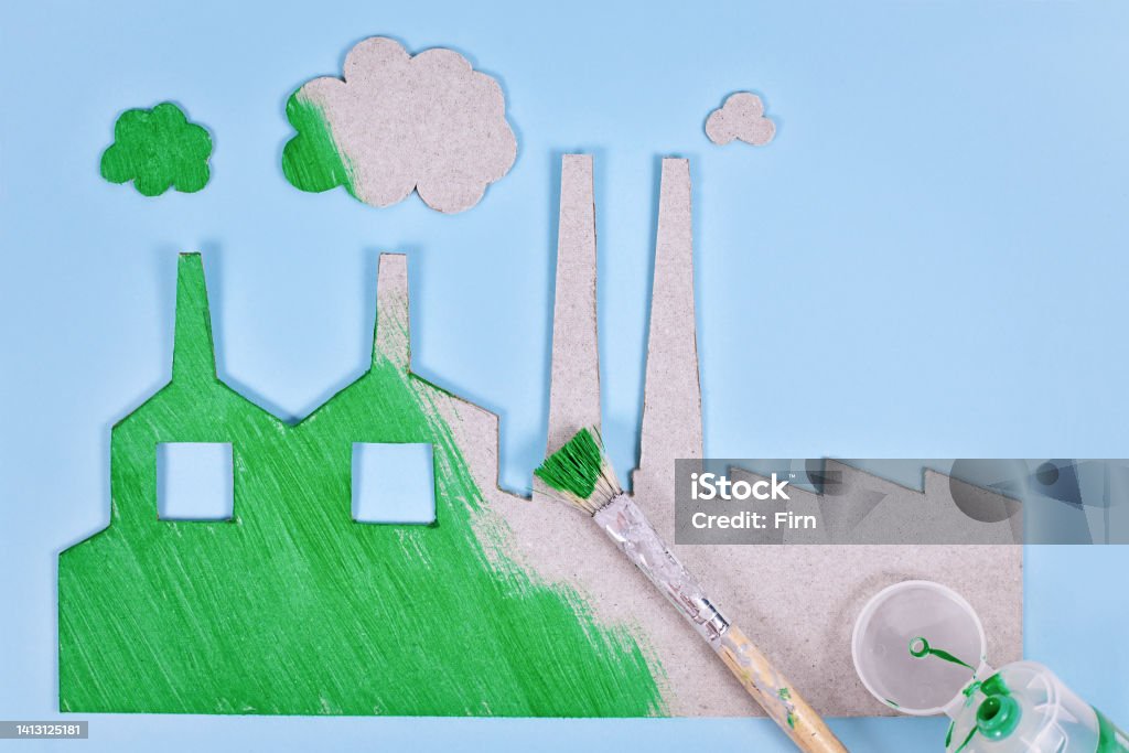 Greenwashing concept Greenwashing concept with cardboard factory being painted green Greenwashing Stock Photo