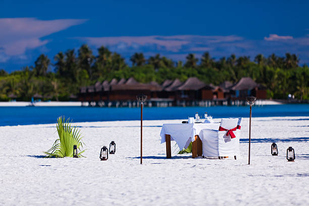 istock Table and chairs setup for lunch on the beach 141312856
