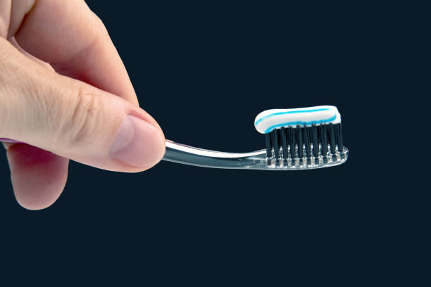 istock toothbrush with toothpaste for cleaning teeth on a dark background. health care 1413128922