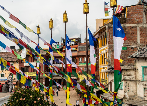 Kathmandu , Nepal - oct 30, 2019: flags flutter in the wind in front of the houses surrounding the Boudhanath stupa in Kathmandu