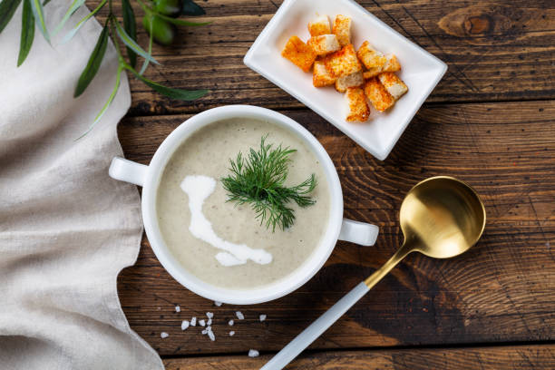 mushroom soup in a white bowl,  view from above. copy space stock photo