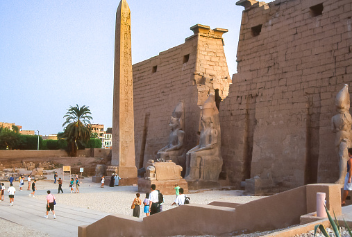 Luxor, Egypt - aug 10, 1991: view of the first entrance pylon to the Temple, with statues of the pharaoh RamsesII and the remaining obelisk, the second was brought to Paris