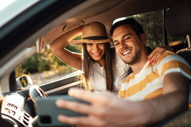 istock Happy young couple enjoying driving together 1413136192