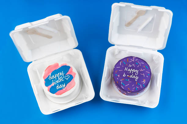 bento cakes A small cakes in a lunchboxes on a blue background. birthday cakes. Asian food trend. Cute gift for any holiday. Copy space stock photo