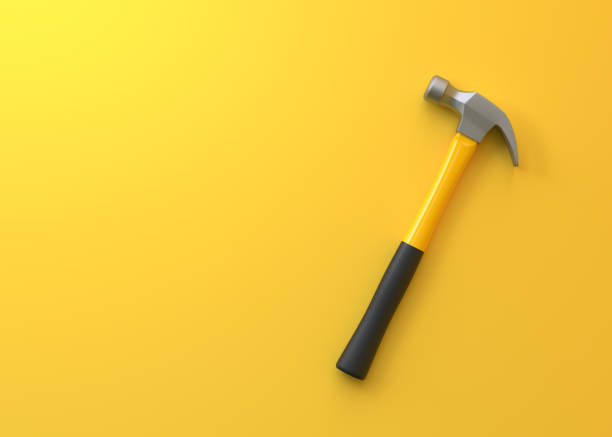 istock Claw hammer with yellow plastic handle isolated on yellow background 1413138218