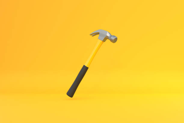 istock Claw hammer with yellow plastic handle isolated on yellow background 1413138222