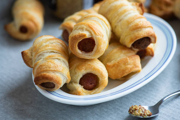 istock Pigs in a blanket - mini sausage roll on a plate. 1413141253