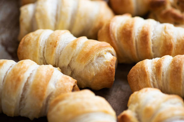istock Pigs in a blanket - puff pastry baking with sausages. 1413141262