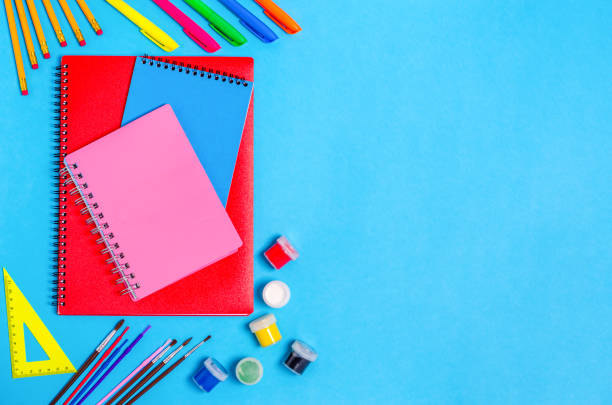 istock Notebooks with stationery accessories on a blue background. 1413141929
