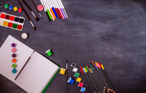 istock Open notebook with a place for tex and stationery accessories on a black background. 1413141942